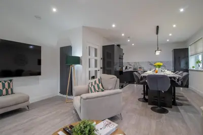 a living room with a table and a dining room at William Wallace View - 5 Bedrooms in Stirling in Stirling