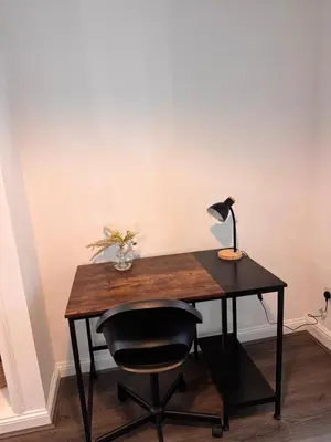 a desk with a lamp and a chair at Stay With OG - Modern Two-Bedroom Apartment in Moffat