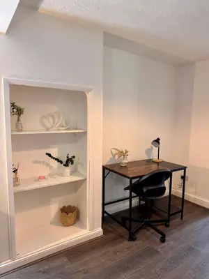 an office with a desk and shelves in a room at Stay With OG - Modern Two-Bedroom Apartment in Moffat