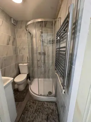a bathroom with a shower and a toilet at Stay With OG - Modern Two-Bedroom Apartment in Moffat