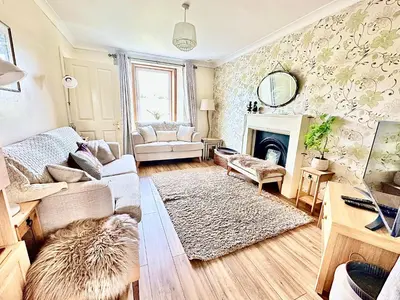 a living room with a couch and a fireplace at Craig Na Barnach in Furnace