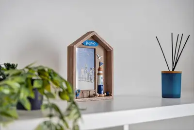 a picture frame sitting on a shelf next to a plant at Troon Golf by the Sea in Troon