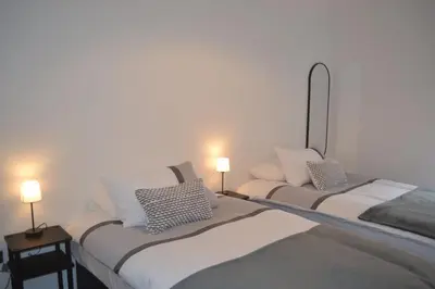 two beds in a room with two lamps on them at Large 8 Bed Group and Contractor Accommodation in Stirling