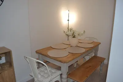 a dining room table with a vase of flowers on it at Large 8 Bed Group and Contractor Accommodation in Stirling