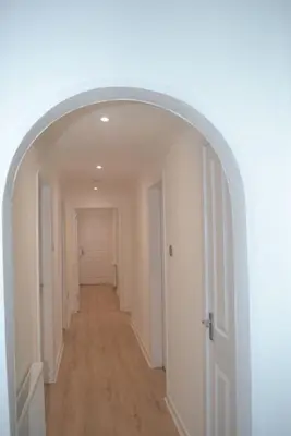 an empty hallway with an archway in a house at Large 8 Bed Group and Contractor Accommodation in Stirling