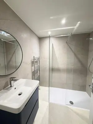 a bathroom with a white sink and a shower at Large 8 Bed Group and Contractor Accommodation in Stirling