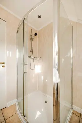 a shower with a glass door in a bathroom at Stunning Sea Views - 3BD & Free Parking in Oban