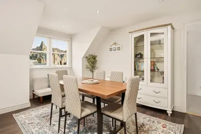 a dining room with a wooden table and chairs at Stunning Sea Views - 3BD & Free Parking in Oban