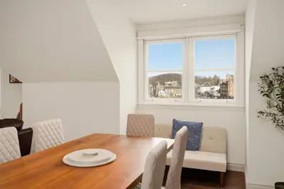 a dining room with a table and chairs and a window at Stunning Sea Views - 3BD & Free Parking in Oban