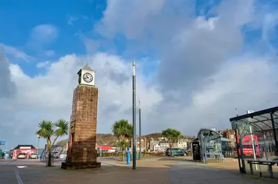 a clock tower in the middle of a street at Stunning Sea Views - 3BD & Free Parking in Oban