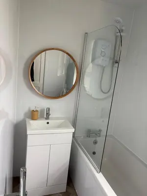 a bathroom with a sink and a shower and a mirror at Home in Glasgow3BR -Ziplinks - Sleeps 6 G51 in Glasgow