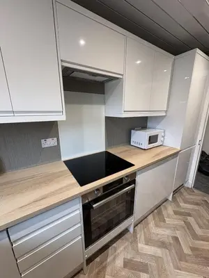 a kitchen with white cabinets and a microwave at Home in Glasgow3BR -Ziplinks - Sleeps 6 G51 in Glasgow