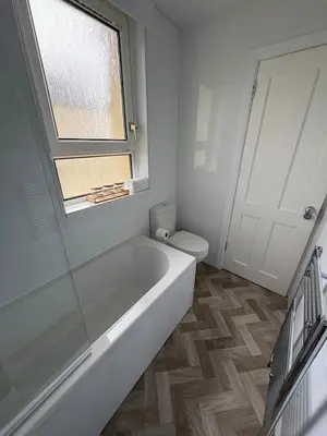 a bathroom with a tub and a toilet and a window at Home in Glasgow3BR -Ziplinks - Sleeps 6 G51 in Glasgow