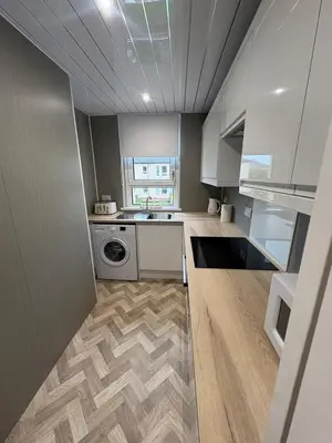 a kitchen with a sink and a washing machine at Home in Glasgow3BR -Ziplinks - Sleeps 6 G51 in Glasgow