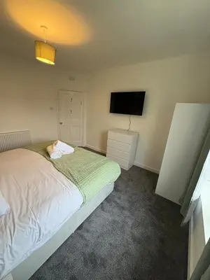 a bedroom with a bed and a flat screen tv at Home in Glasgow3BR -Ziplinks - Sleeps 6 G51 in Glasgow