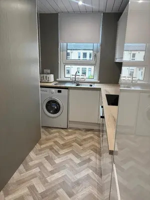 a kitchen with a sink and a washing machine at Home in Glasgow3BR -Ziplinks - Sleeps 6 G51 in Glasgow