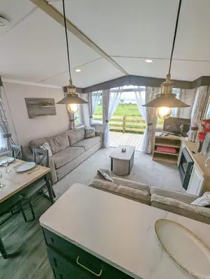a living room with a couch and a table at Swift Bordeaux Sea View No 2 in Dunoon