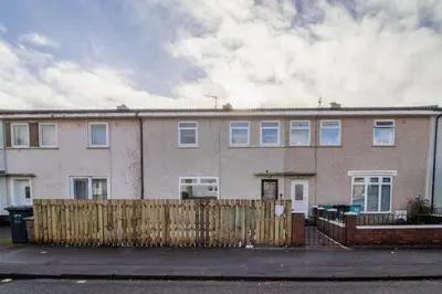 a large brick house with a fence in front of it at Betty's House - 3 bedroom in Coatbridge in Glenboig