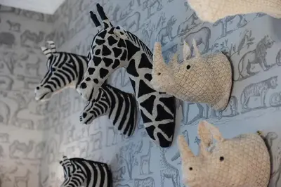 a group of stuffed giraffes and zebras on a wall at The Painted Cow in Beattock