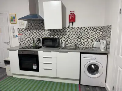 a kitchen with a sink and a washing machine at #127 Modern City Suite Digbeth Creative Quarter in Moffat