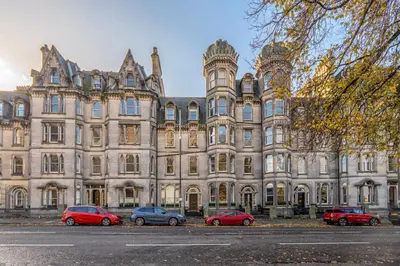 a large building with cars parked in front of it at Old Town Castle View 4 Bedroom 5 beds Sleeps 10 in Edinburgh