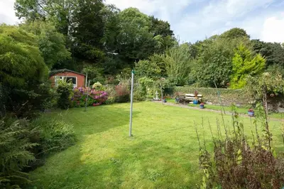 a yard with a sign in the grass at 25 Ardbeg Road in Rothesay