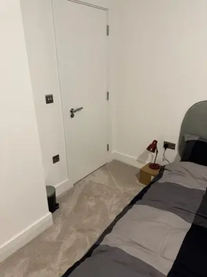 a bedroom with a bed and a white door at Colindale Condominium in Moffat