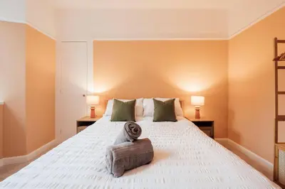 a bedroom with a large white bed with two lamps at Sea View, 2 Bed Apartment, Central Largs in Largs