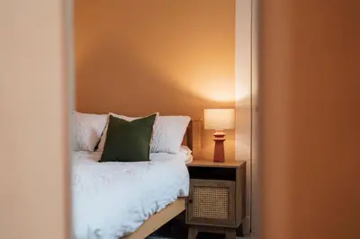 a bedroom with a bed and a mirror at Sea View, 2 Bed Apartment, Central Largs in Largs