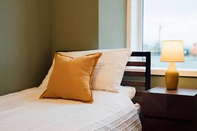 a bedroom with a bed with a lamp and a window at Sea View, 2 Bed Apartment, Central Largs in Largs