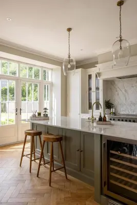 a kitchen with a large island with two stools at The Hollies Argyll in Tighnabruaich