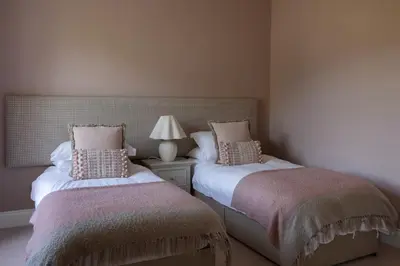 two beds sitting next to each other in a bedroom at The Hollies Argyll in Tighnabruaich