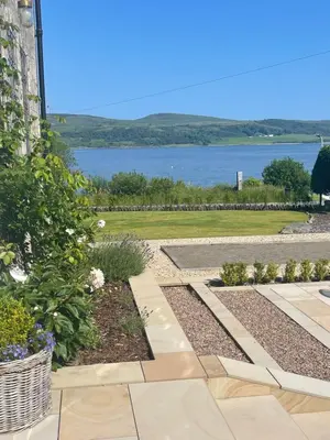 a garden with a view of the water at The Hollies Argyll in Tighnabruaich