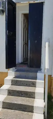 an entrance to a building with a door and stairs at Corsewall Lighthouse Hotel in Kirkcolm