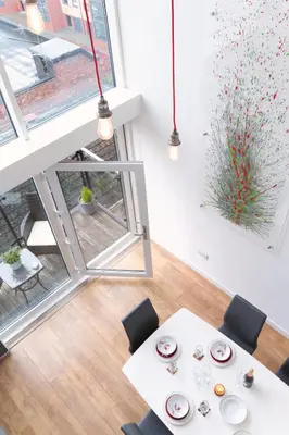a dining room with a table and chairs and a window at CITY CENTRE APARTMENT with Free Secure Underground Parking in Glasgow