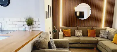a living room with a couch and a table at Elmbank Garden Apartment in Oban