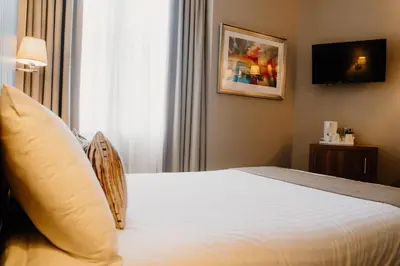 a hotel room with a bed and a window at Frederick House Hotel in Edinburgh