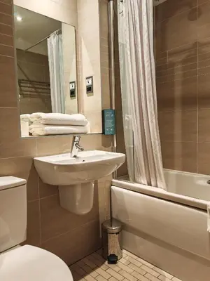 a bathroom with a sink and a toilet and a tub at Frederick House Hotel in Edinburgh