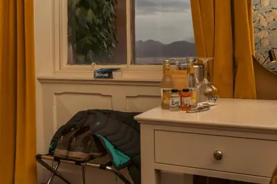 a table with bottles on it next to a window at The Ballachulish Hotel in Glencoe