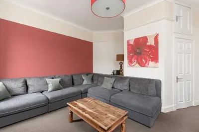 a living room with a gray couch and a wooden coffee table at Rose Street Residence in Edinburgh
