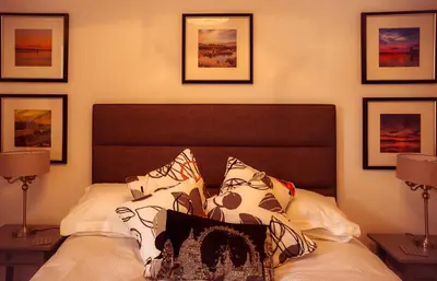 a bedroom with a bed with pillows on it at Dana Villa Holiday Accommodation in Oban
