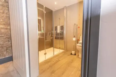 a bathroom with a shower and a toilet at Court Residence Aparthotel in Linlithgow