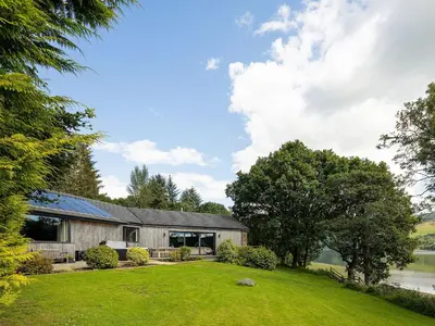 an exterior view of a house with a yard at Carsaig in Port of Menteith