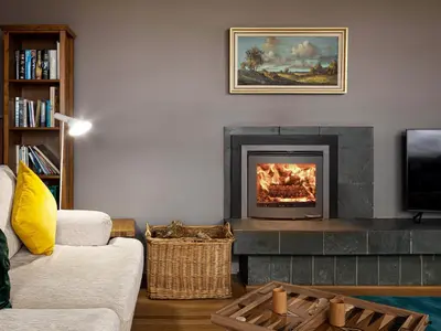 a living room with a fireplace and a tv at Carsaig in Port of Menteith