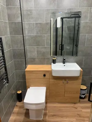a bathroom with a sink and a toilet and a mirror at Modern Grassmarket Apartment in Edinburgh