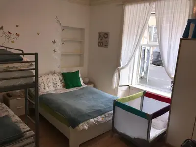 a small bedroom with a bed and a window at Edinburgh Central Apartment in Edinburgh