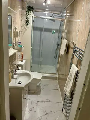 a bathroom with a shower and a sink and a toilet at Edinburgh Central Apartment in Edinburgh