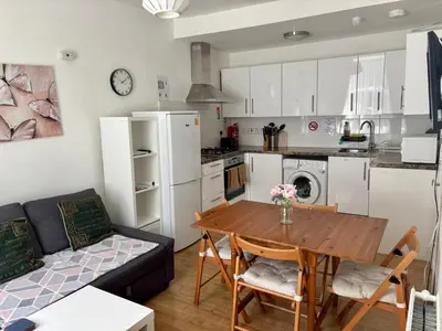 a kitchen and living room with a table and a couch at Edinburgh Central Apartment in Edinburgh