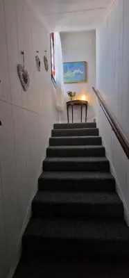 a staircase in a building with a table on it at Morris Terrace Apartment in Stirling