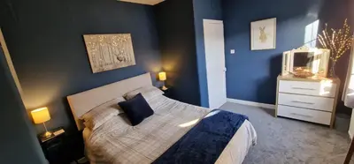 a bedroom with a bed and a television in it at Morris Terrace Apartment in Stirling